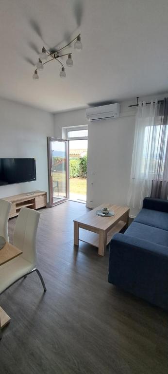 a living room with a bed and a couch and a table at Apartma Rian in Koper