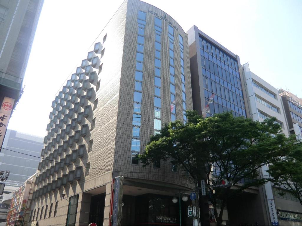 a tall building in the middle of a city at Hotel Century Art in Fukuoka