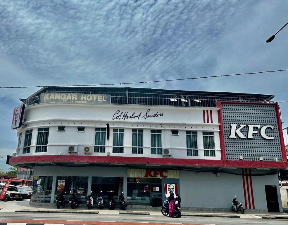 a white building with motorcycles parked in front of it at Kangar Hotel Sdn Bhd in Kangar