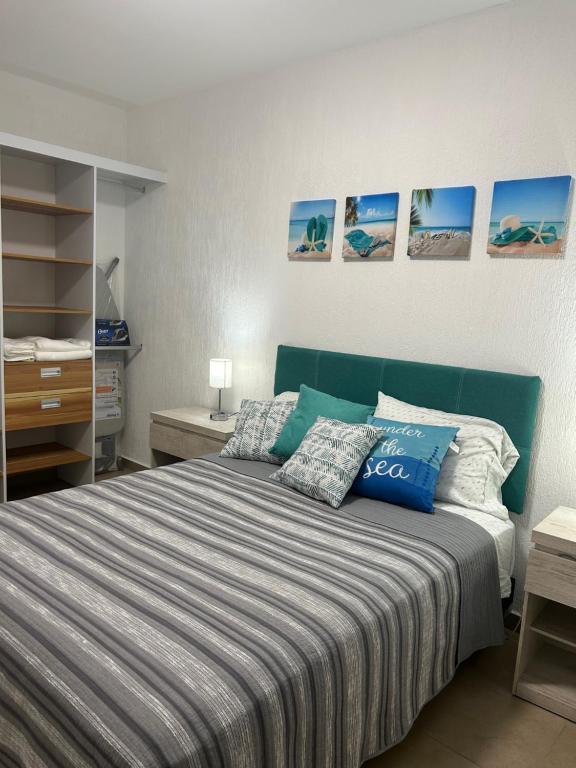 a bedroom with a bed with a blue head board at Cancun15 3 Bedrooms with private Bathrooms 15 min Airport 20 min Beach in Cancún