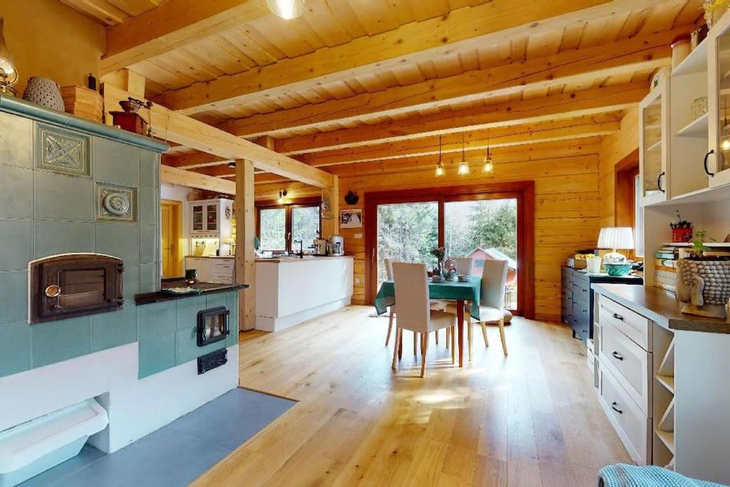 a kitchen and dining room with a table in a cabin at Chata Vysoké Tatry in Stará Lesná