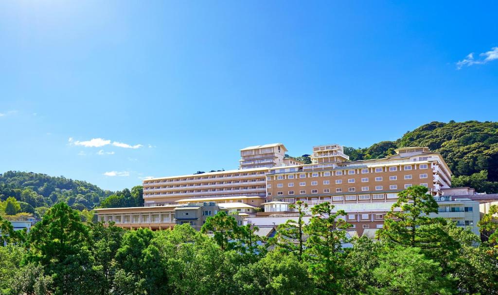 um grande edifício com árvores em frente em The Westin Miyako Kyoto em Quioto