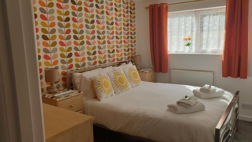 a bedroom with a bed with towels on it at Rock Cottage in Callington