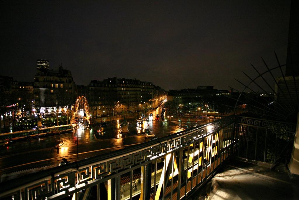 a view of a city at night with lights at Hotel Beauvoir in Paris