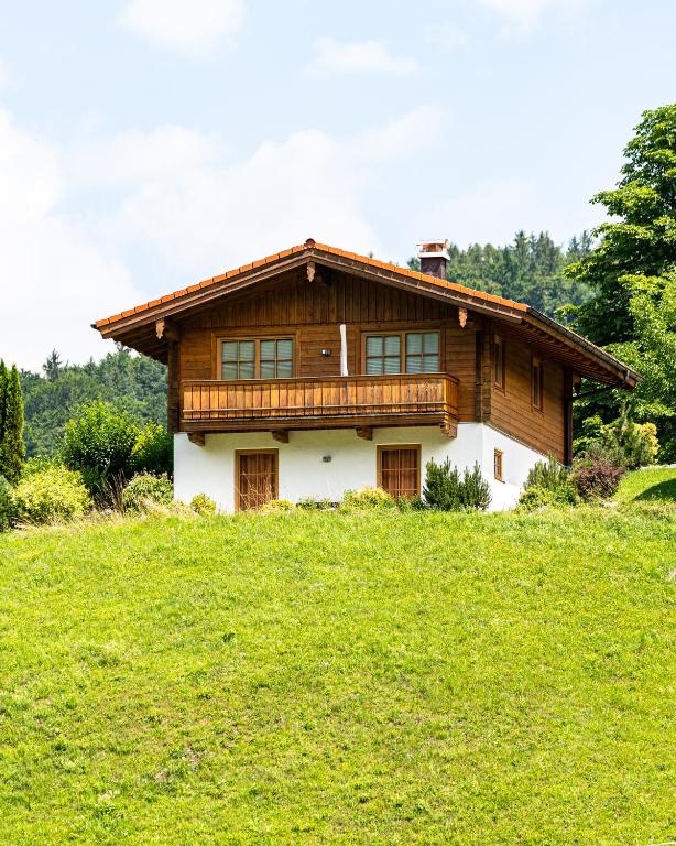 a house on top of a grassy hill at Chalets Lampllehen in Marktschellenberg
