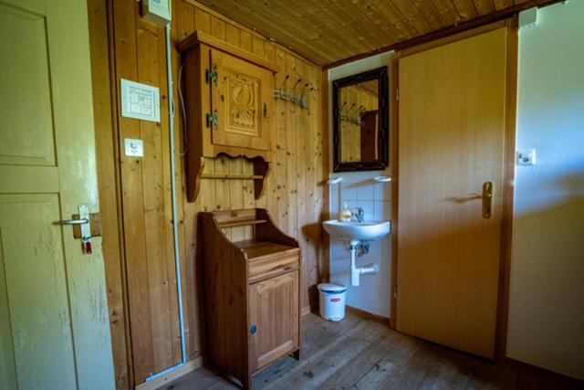 a bathroom with a sink and a toilet and a mirror at Berg-Pension Battagliahütte in Churwalden