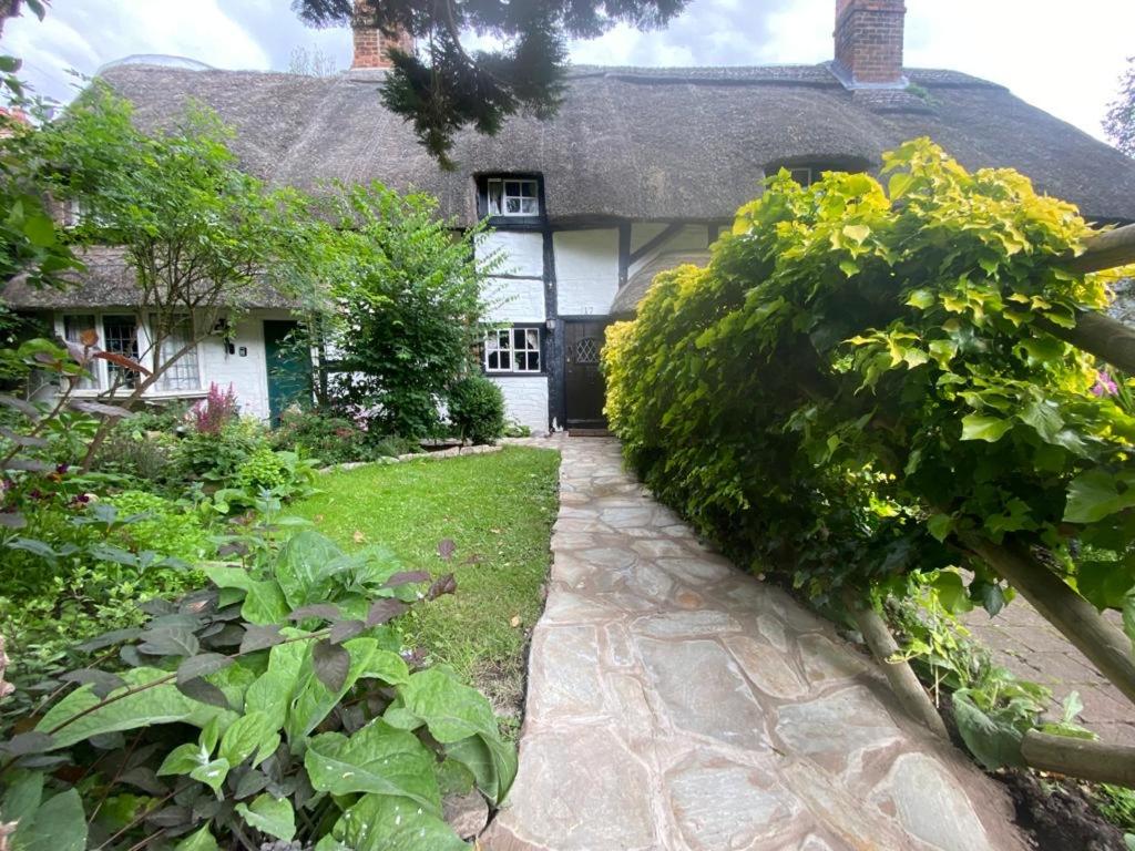 a cottage with a pathway leading to the front door at Old Cottage in Stratford upon Avon in Stratford-upon-Avon