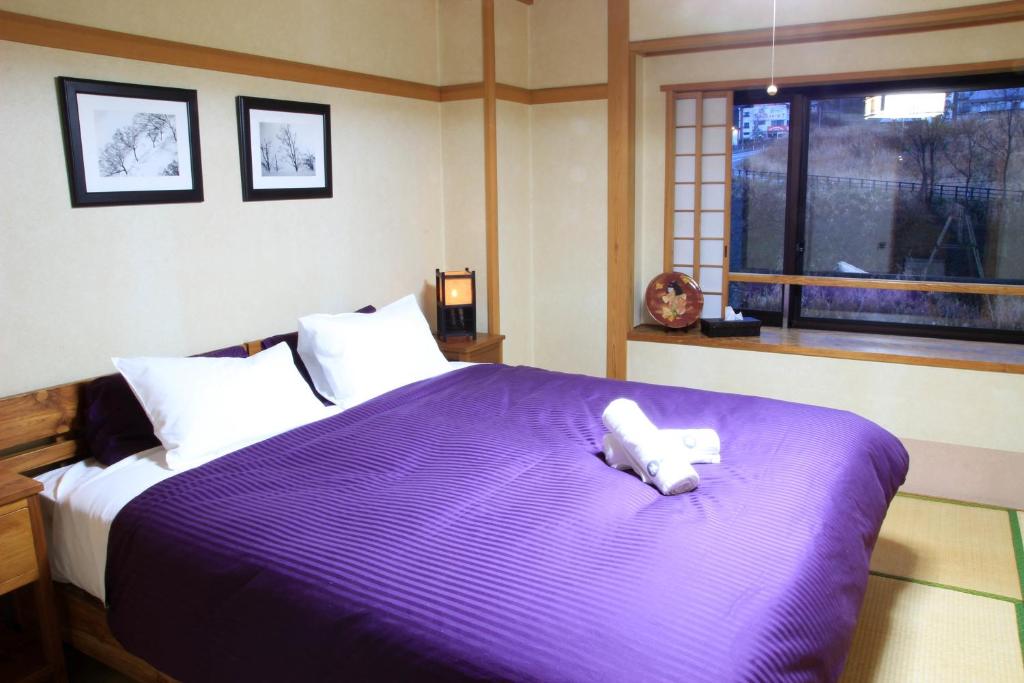 Postel nebo postele na pokoji v ubytování Morino Lodge - Myoko