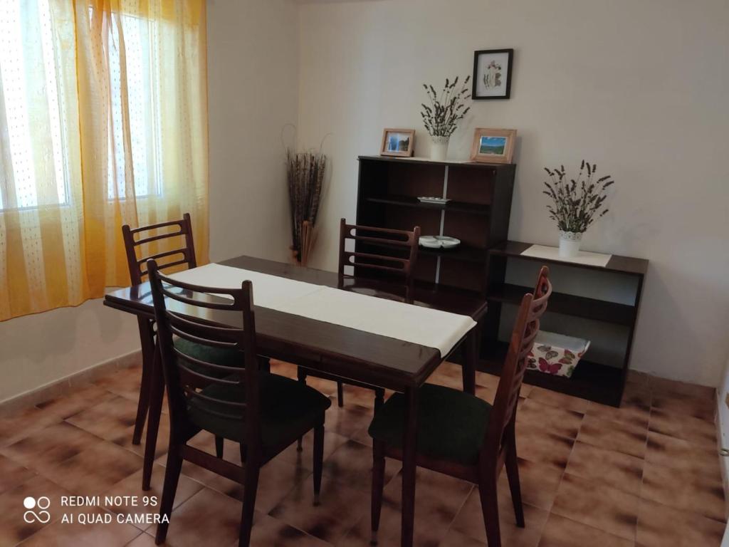 a dining room with a table and chairs at Apartments Nino in Štivan