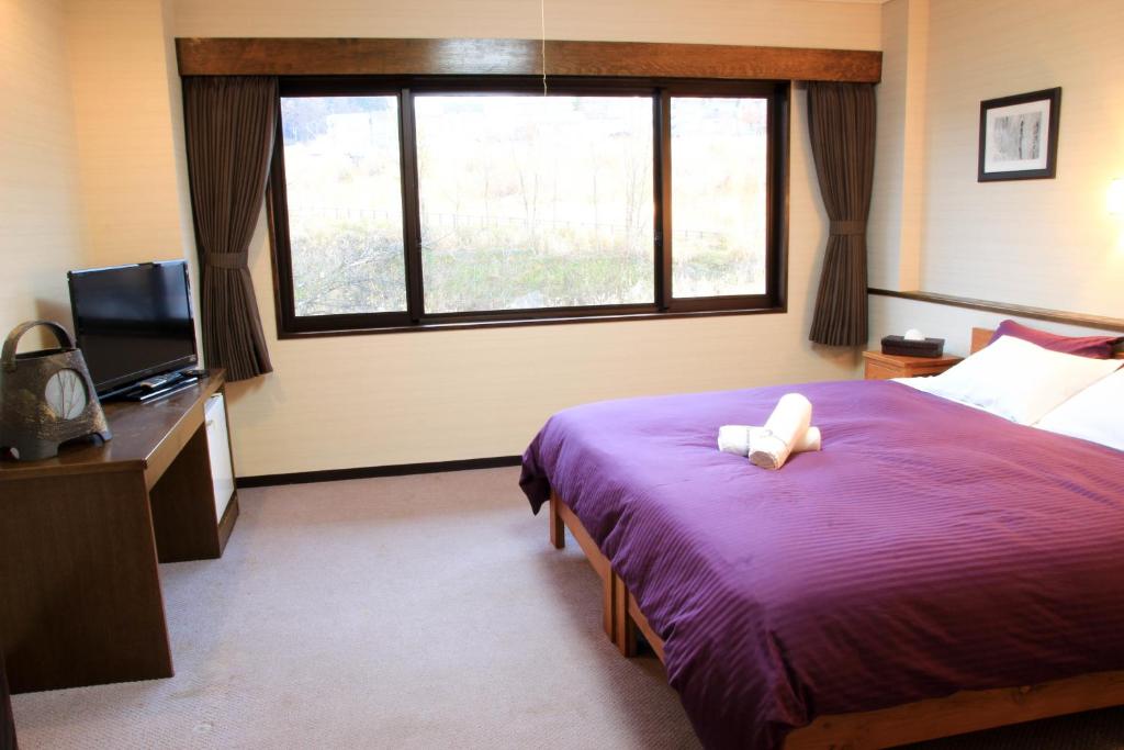 Postel nebo postele na pokoji v ubytování Morino Lodge - Myoko