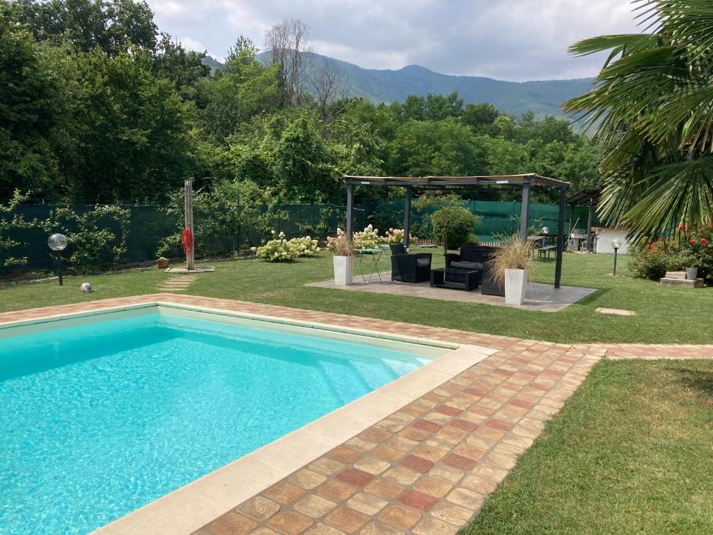 a swimming pool in a yard with a gazebo at CasaD in San Gillio