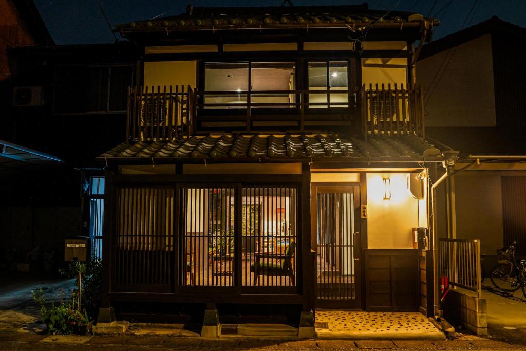 a building with a gate in front of it at night at 游月庵 in Inuyama