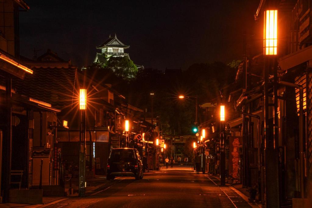 a city street at night with a building in the background at 游月庵 in Inuyama