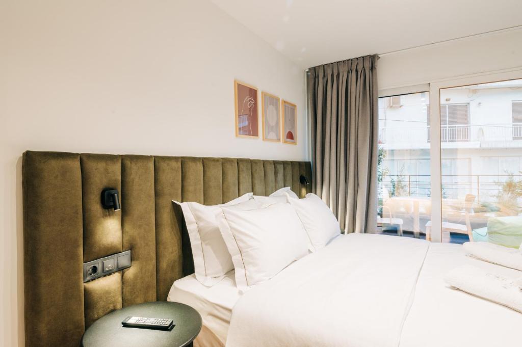 Postel nebo postele na pokoji v ubytování Athesense Suites