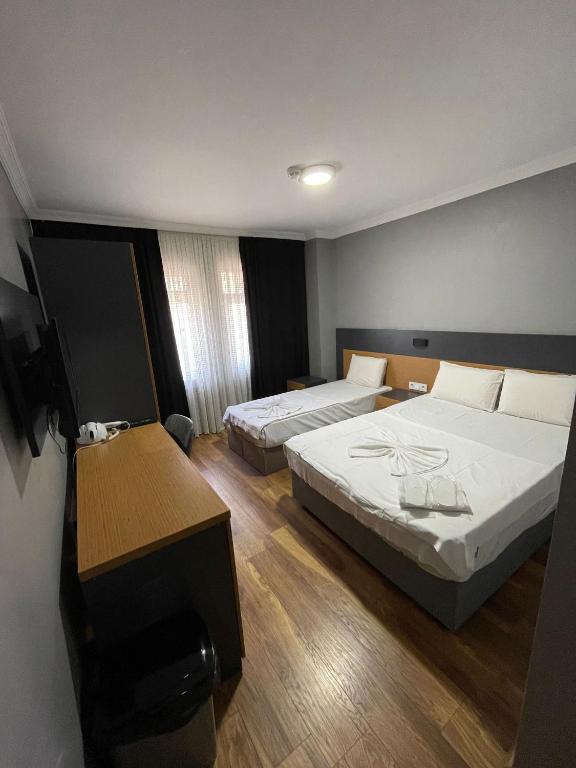 A bed or beds in a room at Hotel Otağ