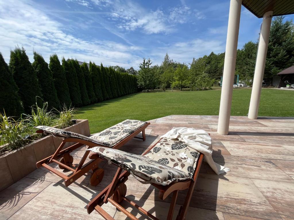 two chairs and a table on a patio at LakeHouse in Giewartów