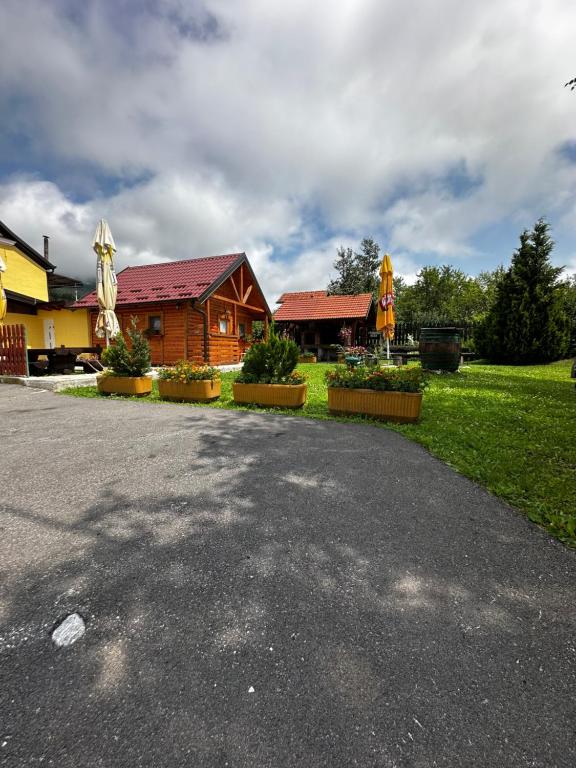 a house with a driveway in front of a house at Holiday house Radić in Sošice