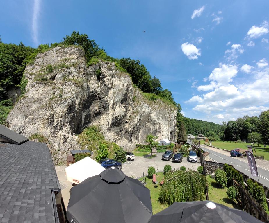 a view of a mountain with cars parked in a parking lot at Zajazd Wernyhora in Sułoszowa