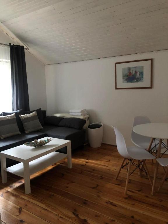 a living room with a couch and a table at Summer House in Lubniewice