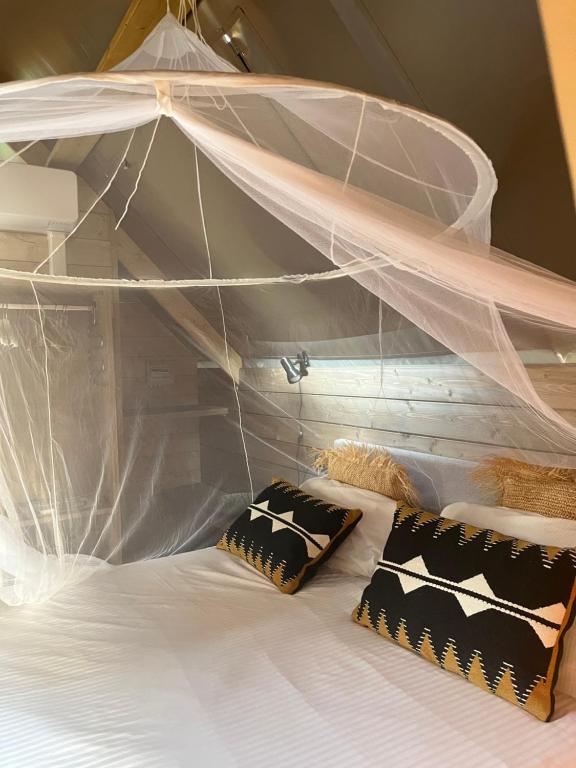 a white bunk bed with two pillows on it at Glamping Tuscany - Podere Cortesi in Santa Luce