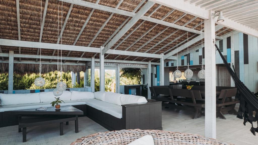 a living room with a white couch and a table at Beach Houses Moitas in Amontada