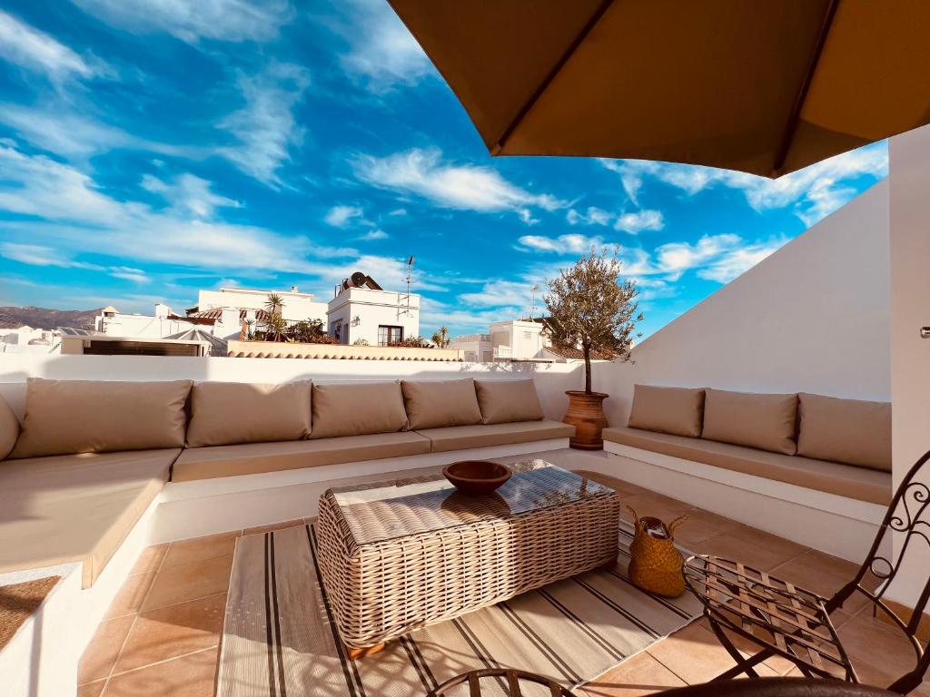 a living room with a couch and a table at Hostal Boutique Plaza Cantarero in Nerja