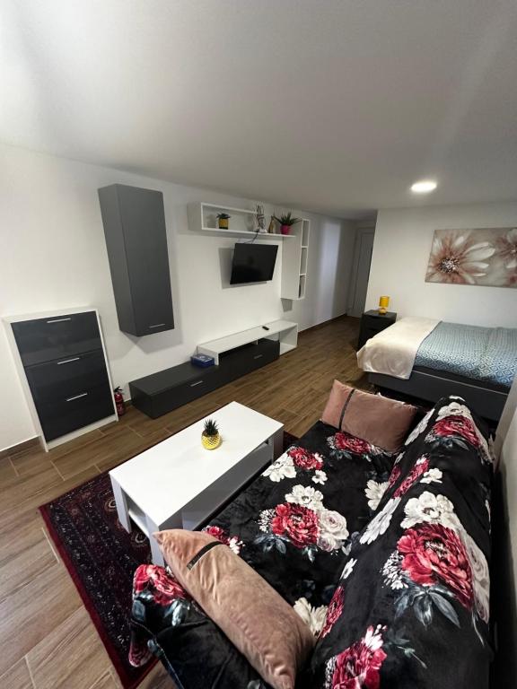 a living room with a couch and a bed at Apartment Radić 1 