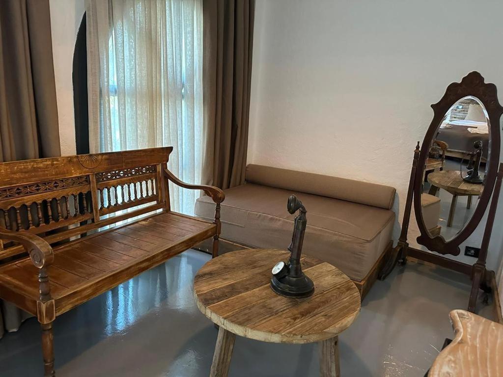 a living room with a couch and a table and a mirror at Argente Alaçatı (Adult Only) in Alacati