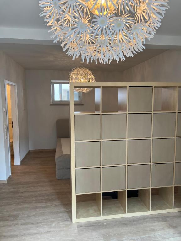 a living room with a large chandelier and a large cabinet at Boardinghouse Rheinfelden 2 in Rheinfelden