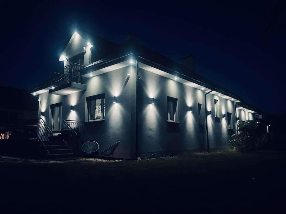 a house with lights on the side of it at night at Dream House SmartHome in Warsaw