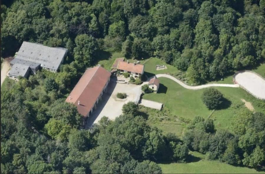 an aerial view of a house in the middle of a forest at Ferme de la Dhuys 