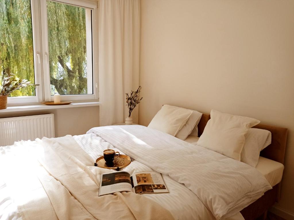 a bedroom with a white bed with a window at Apartament Home Mi in Nysa