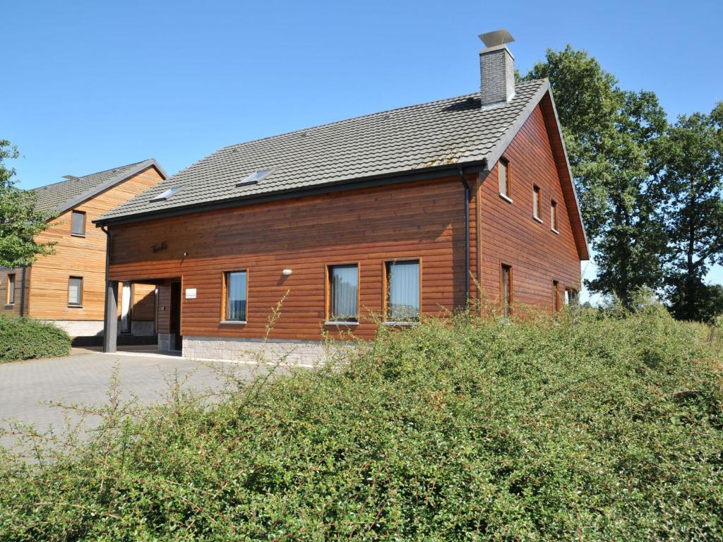 a large wooden house with a gambrel roof at Stunning, wooden villa located in Durbuy in Durbuy