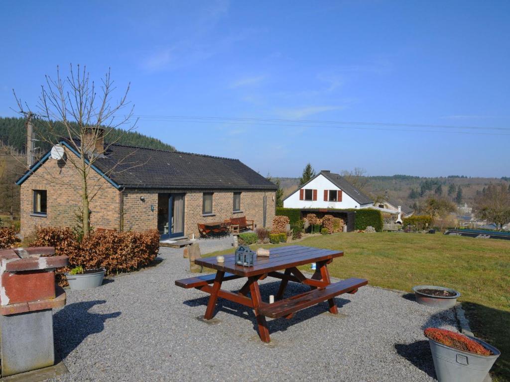 a picnic table in a yard with a house at Attractive holiday home in Hampteau with garden in Hampteau