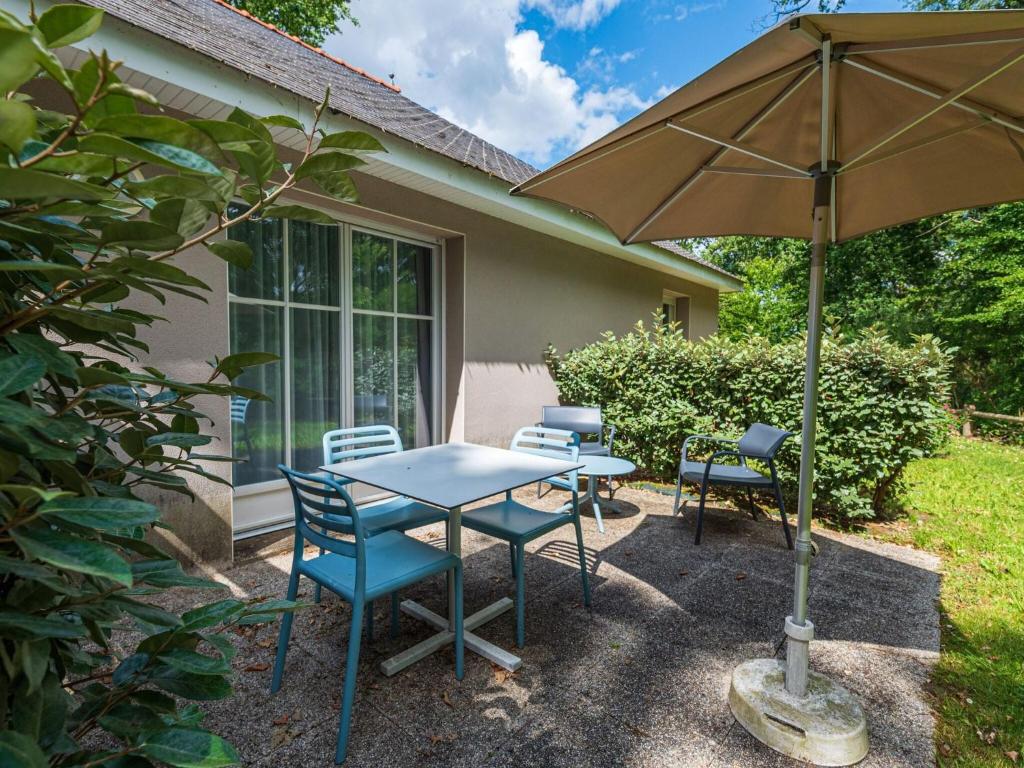 a patio with a table and chairs and an umbrella at Nice studio with included linen package in the Loire in Saumur