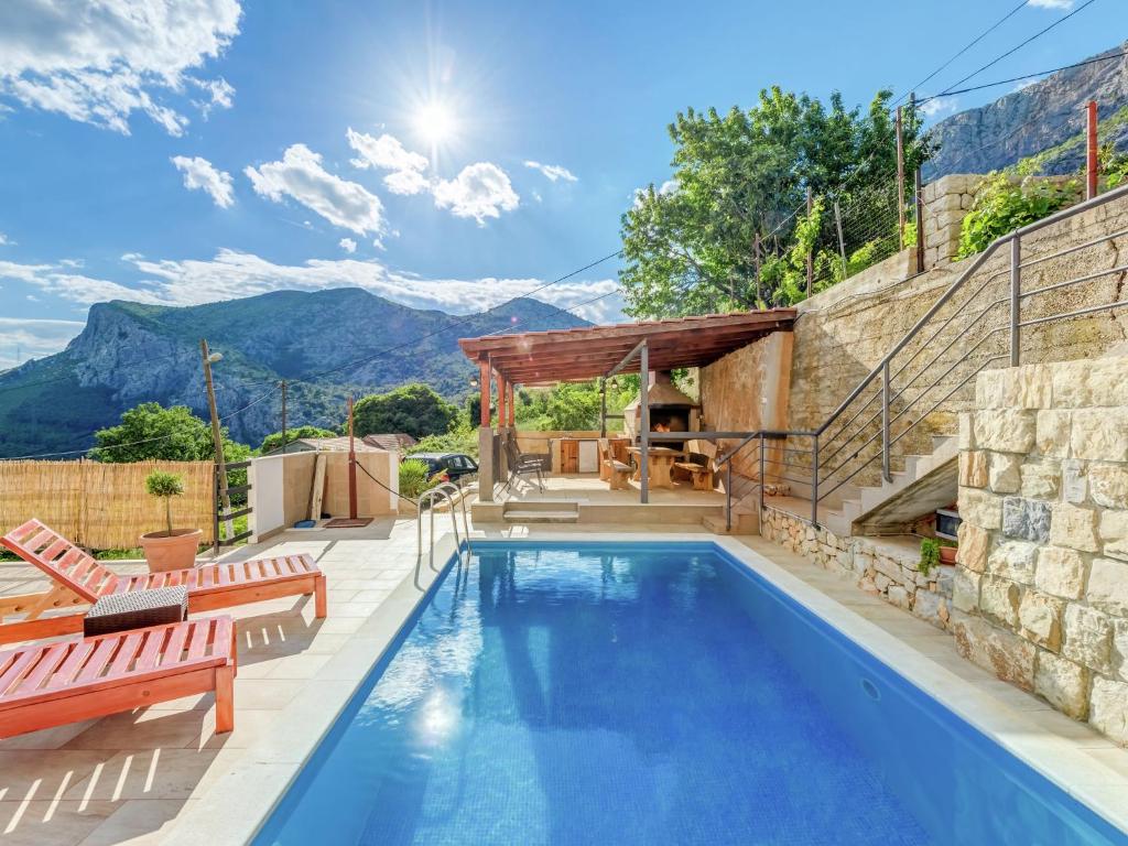 a swimming pool with a patio and a house at Villa in Solin with Private Pool and Garden in Solin