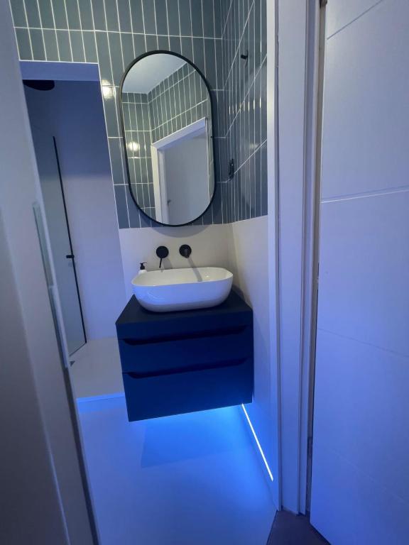 a bathroom with a sink and a mirror at Zadar Enjoy Apartment in Zadar