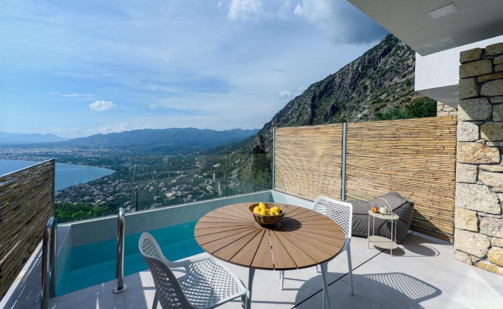 a balcony with a table and chairs and a view at Lithos Retreat 2 in Kalamata
