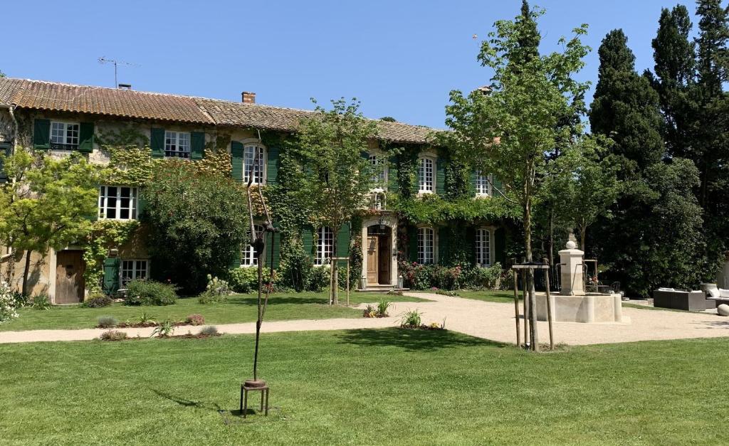 a large building with a garden in front of it at Domaine de Rhodes B&B in Avignon