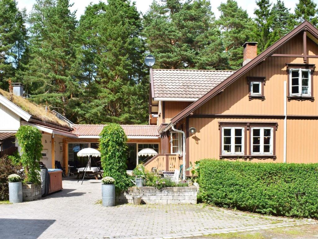 a house with a patio in front of it at Holiday home GAMLE FREDRIKSTAD in Trolldalen