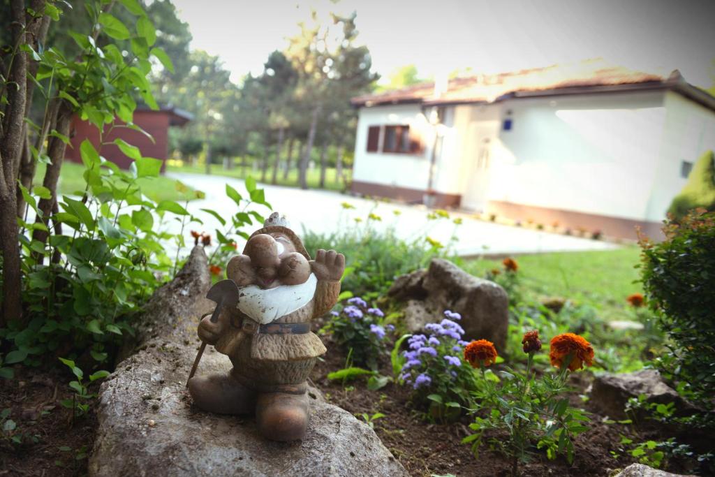 a statue of a person holding aeddy bear on a rock at Kuća za odmor Čanić gaj in Gospić