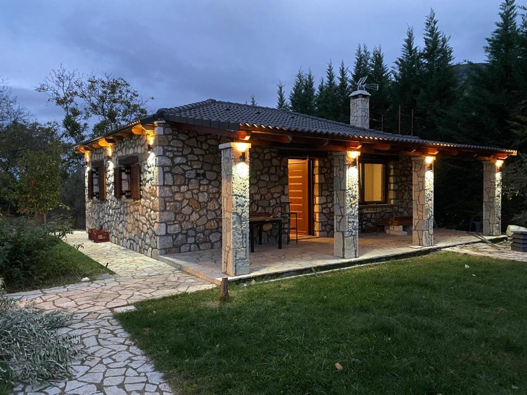 a small stone house with lights on it at Το πετρινο σπιτι του Καστρη! Με θεα τα Μετεωρα in Kalabaka