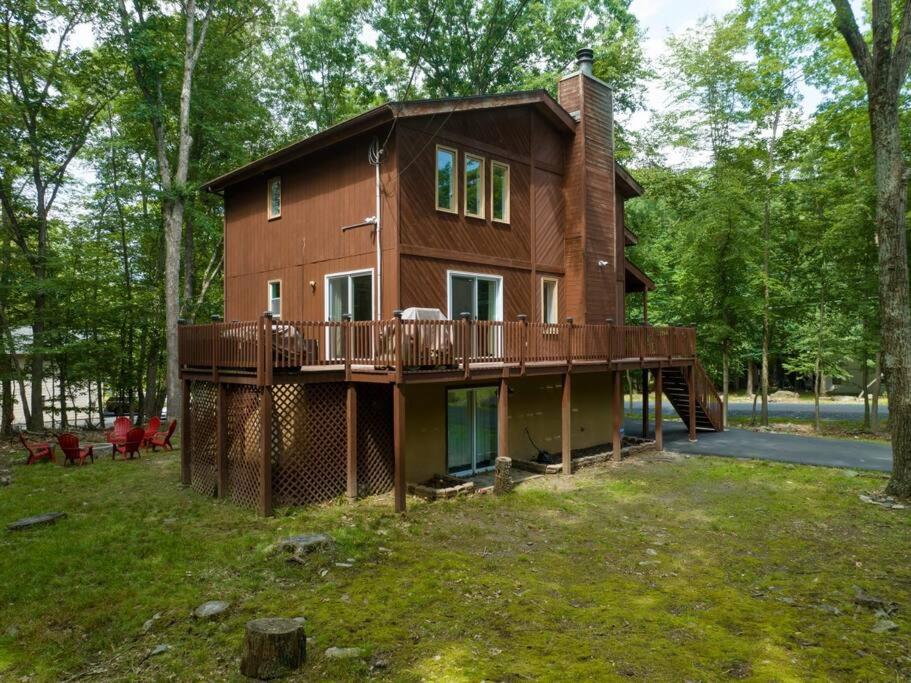a large wooden house with a deck in the yard at Cozy Chalet Game Rm and Fireplace in East Stroudsburg