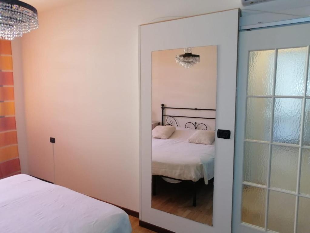 a bedroom with a door leading to a bed at Appartamento Angela in Cento