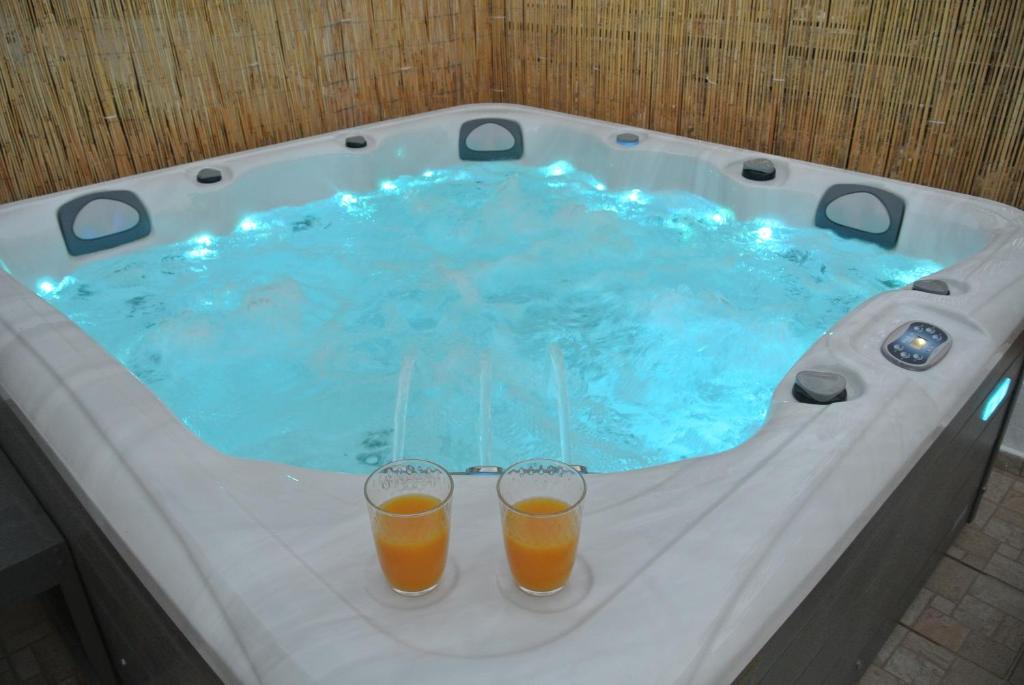 two glasses of orange juice sitting in a hot tub at House Aggeliki Private Hot Tub in Kissós