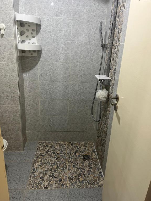 a bathroom with a shower with a glass door at Superbe appartement à côté de la plage M'diq,Tétouan in M'diq