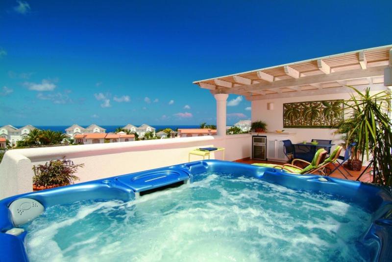 a large blue hot tub on top of a house at Sunny Vacation Villa No 13 in Saint James