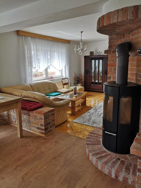 a living room with a fireplace and a couch at Zur Alten Schmiede mit Museum in Rüstungen