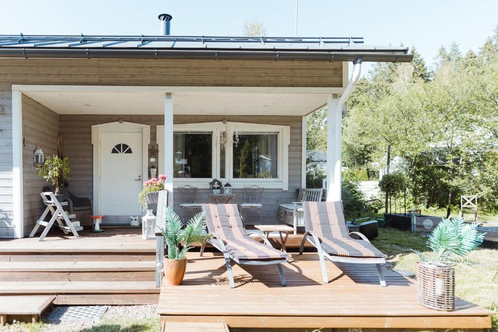 a patio with two chairs and a house at Guest House Marjala in Kotka