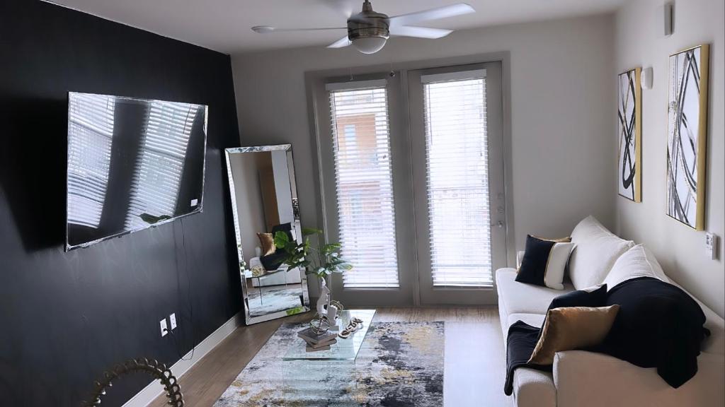 a living room with a couch and a mirror at The Refuge Retreat in Fort Worth